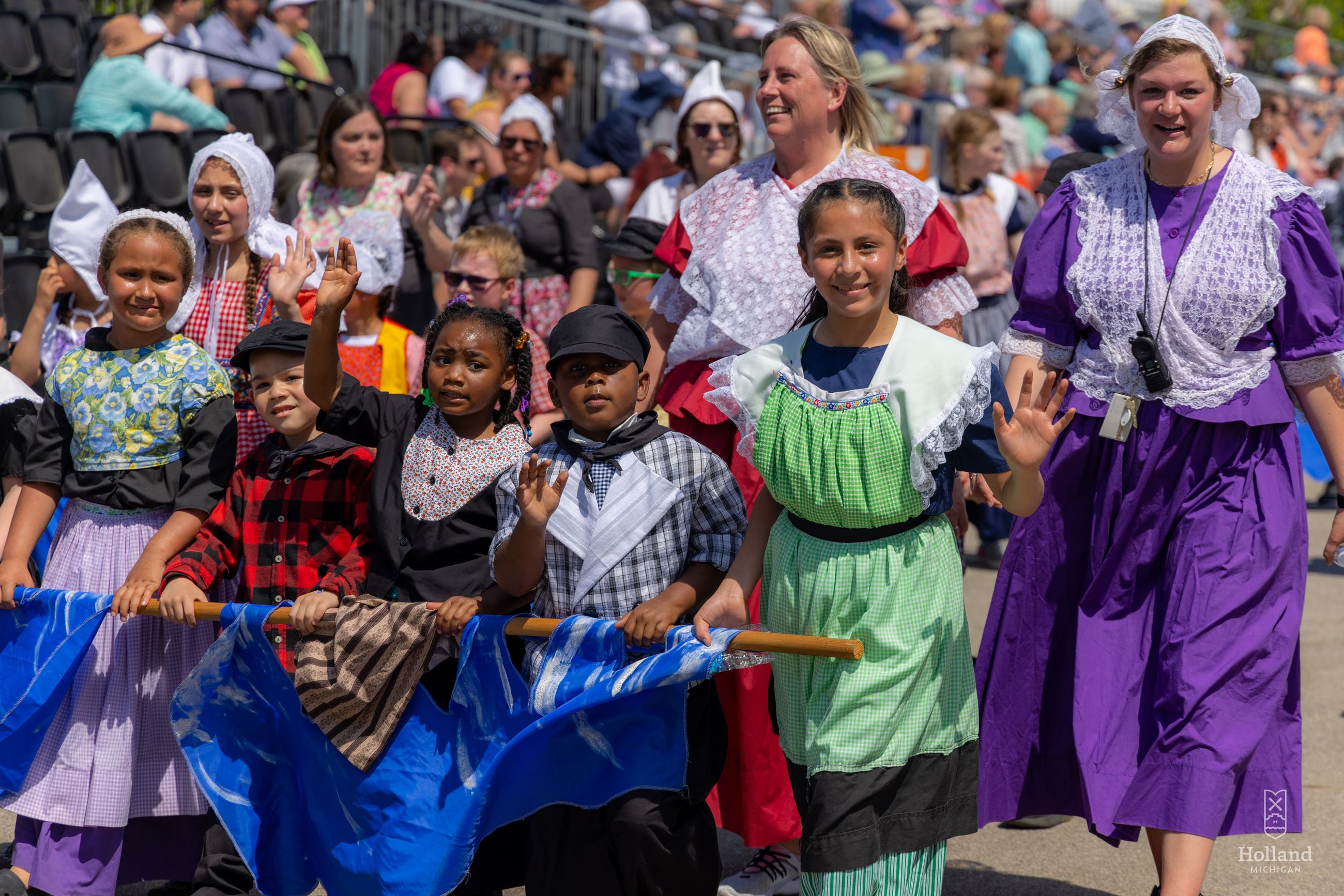 Children and adults dressed in Dutch costumes marching in the Kinderparade