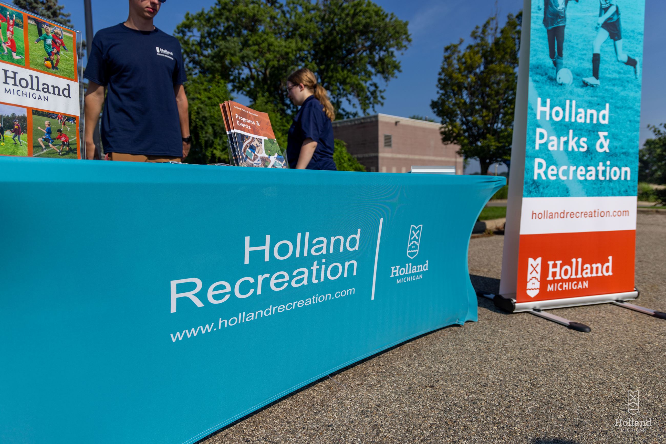 Blue banner covering an 8 ft. table outside