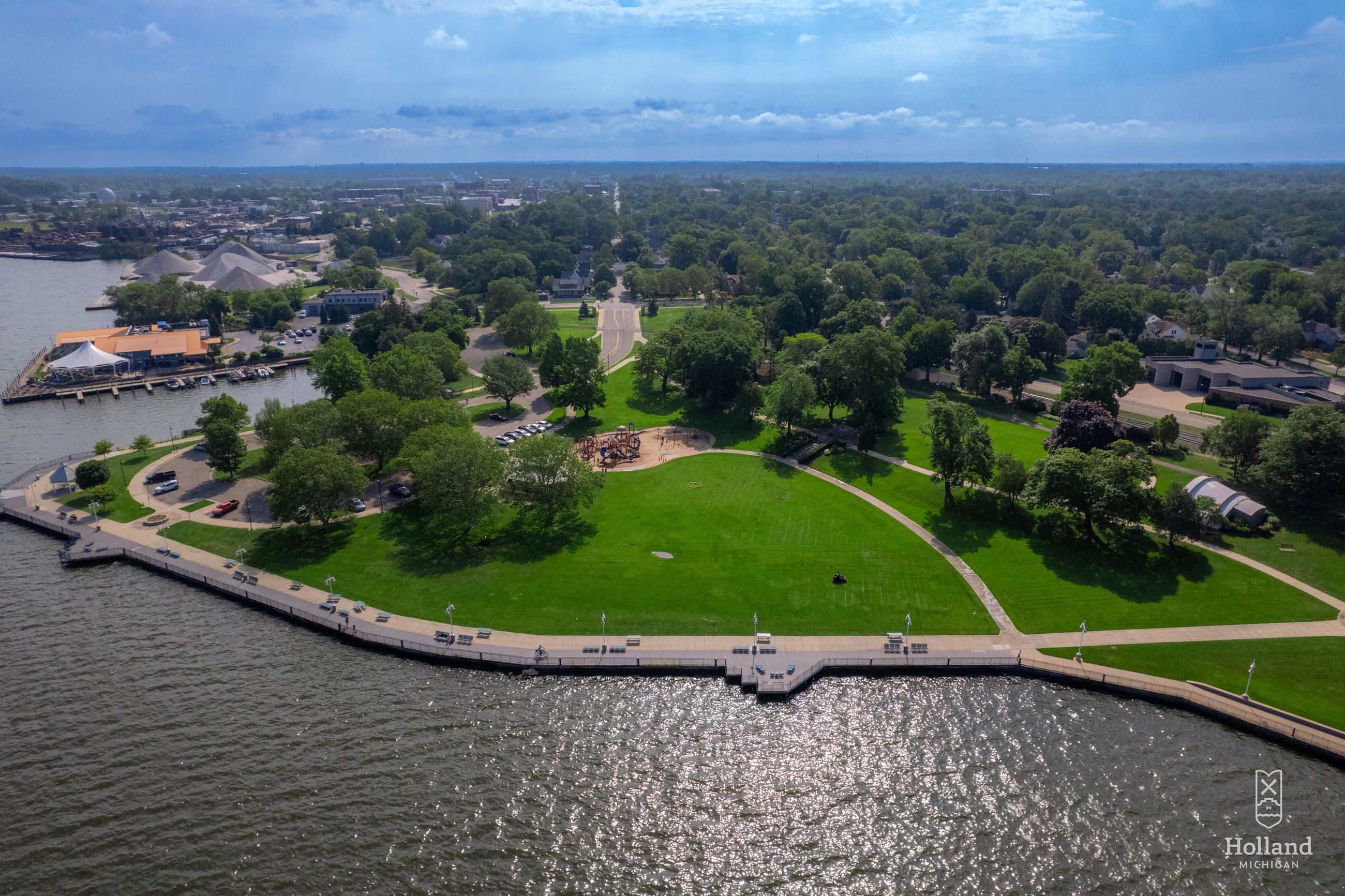 birds-eye view of waterfront park with grass and boadwalk along the waterfront