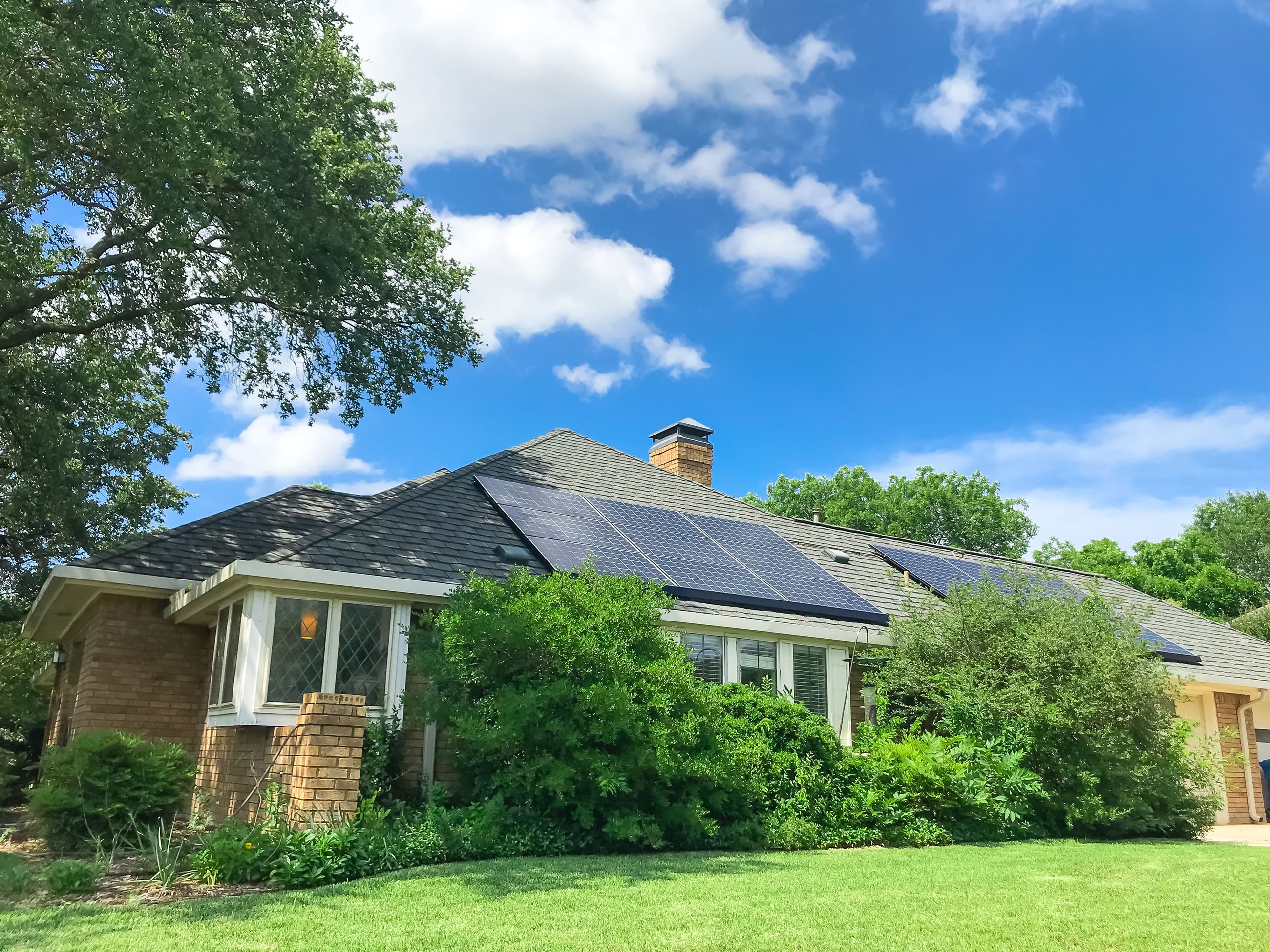 exterior of residential home with solar panels on roof