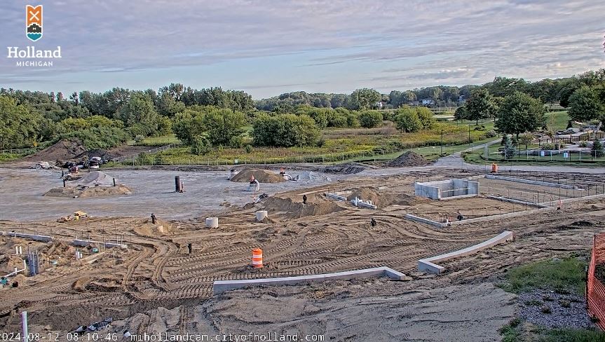 Construction site with dirt and the beginnings of cement foundations