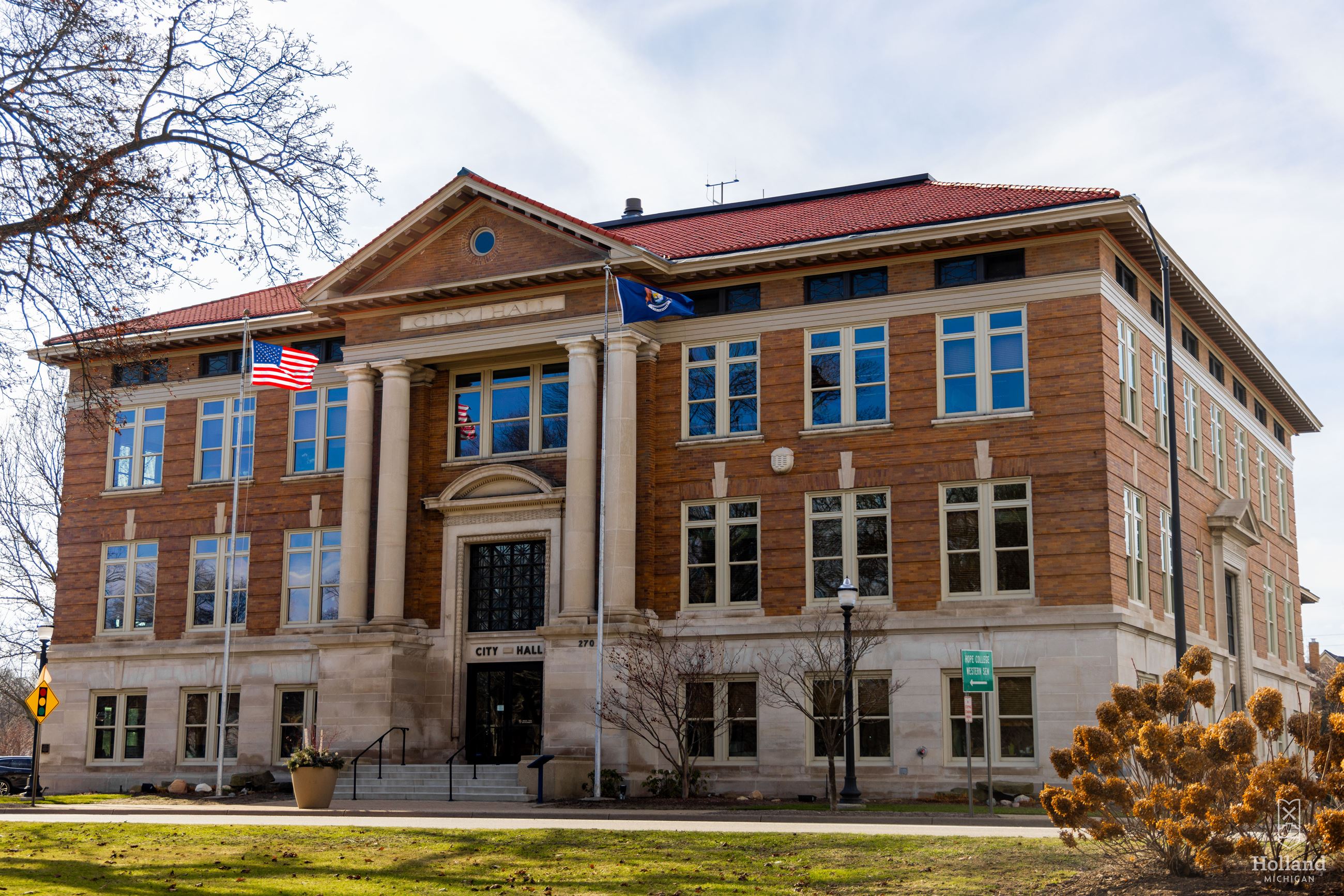 3-story brick building with pillars at front glass doors