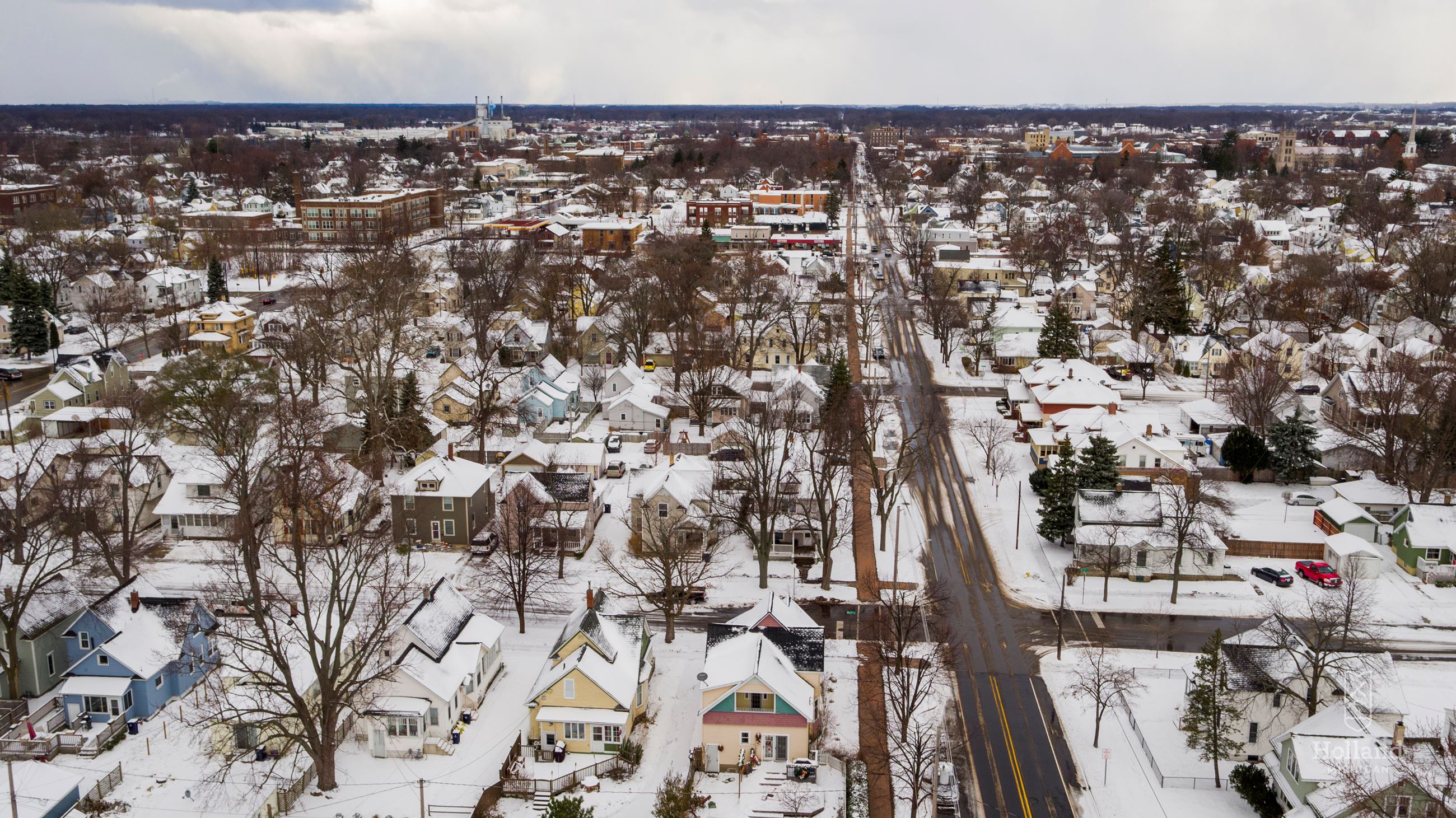 Overhead view of city, with snow covered houses and yards