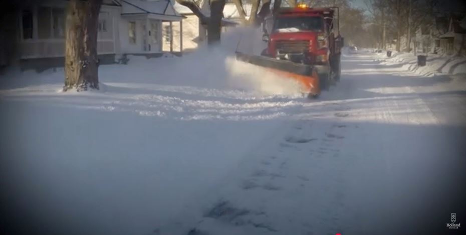Street View of a snow plow plowing heavy snow from the roadway