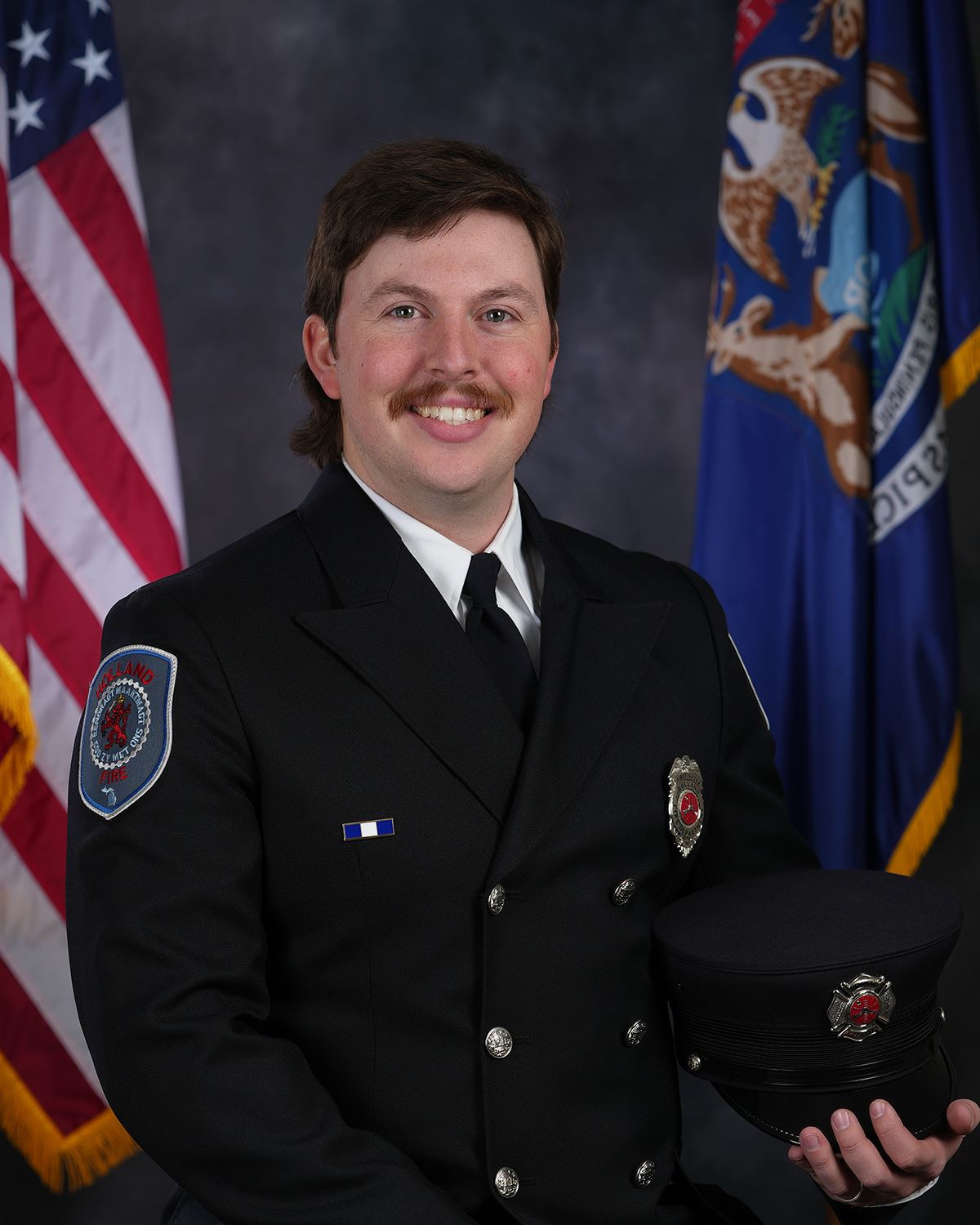 Head and shoulder of a male firefighter in full dress uniform