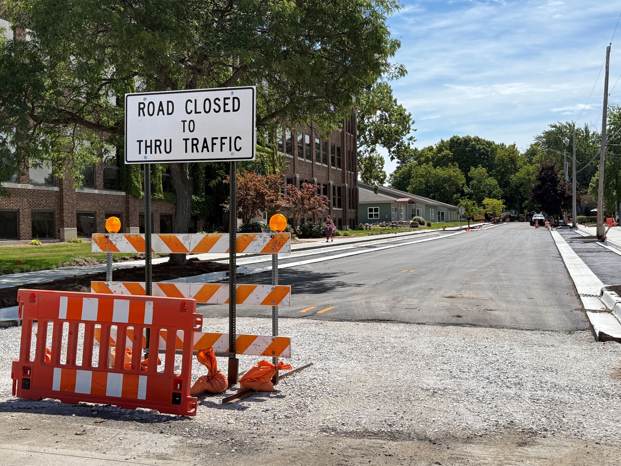 Construction sign in middle of the road reading Road Closed
