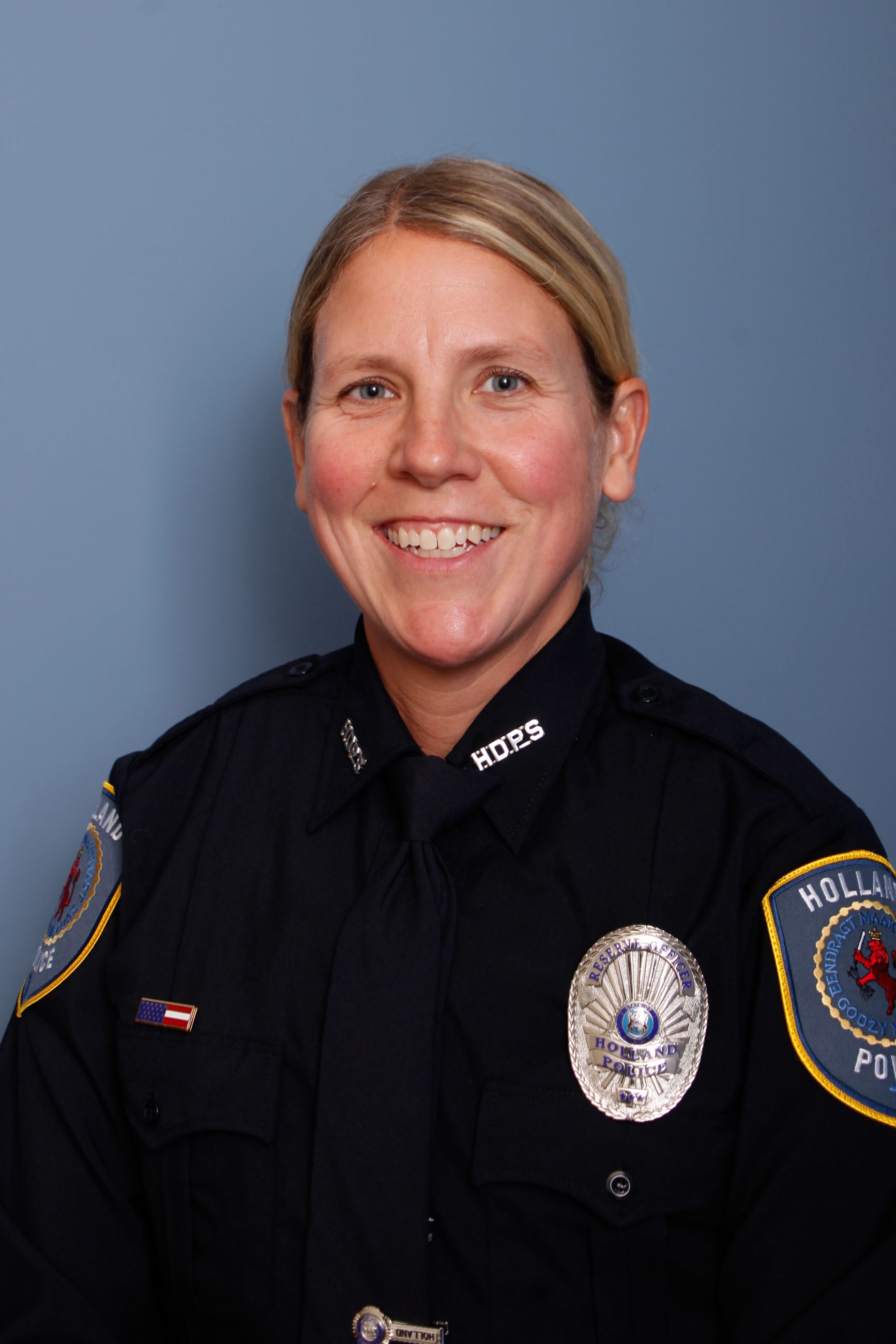 Woman with blonde hair in blue police uniform