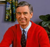 A picture of Fred Rogers wearing a red sweater and tie.
